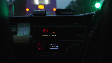 A-taximeter-or-fare-meter-installed-in-a-taxi-cab-car-driving-around-the-modern-city
