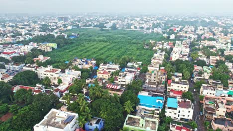 Aerial-Drone-Shot-Of-Greens,-Buildings-And-Sky-Cover-With-Mist-Fog-In-Chennai-India