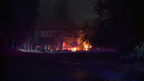 WIDE-SHOT-OF-TRANSFORMER-SUBSTATION-ON-FIRE-AT-NIGHT