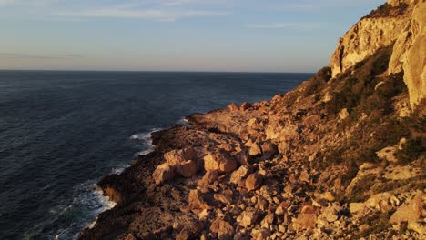Rocky-steep-cliffs-in-to-the-mediterranean-sea-in-Ibiza,-Spain