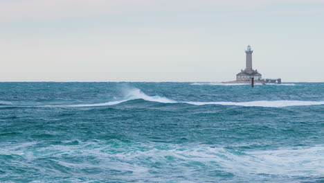 Waves-creating-crest-on-stormy-weather-with-lighthouse-Porer-and-cardinal-mark