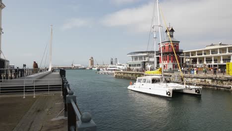 Catamaran-sailboat-motors-past-clocktower-into-Alfred-Basin-Harbour