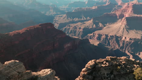 Low-flyover-above-sheer-cliff,-ridge-in-Grand-Canyon-National-Park,-USA