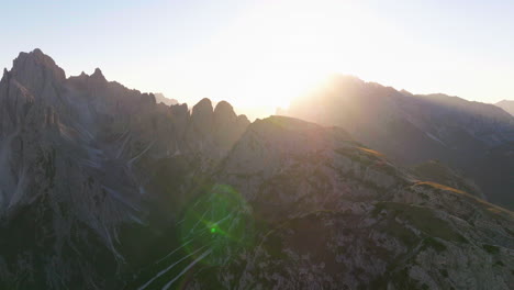Radiant-sunrays-of-Tre-Cime-Dolomites-mountain-landscape-aerial-view-orbiting-breath-taking-South-Tyrol-alps