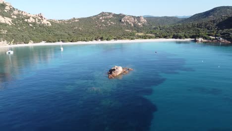 Flying-towards-a-beautiful-beach-with-white-sand-and-cristal-clear-water-in-corsica