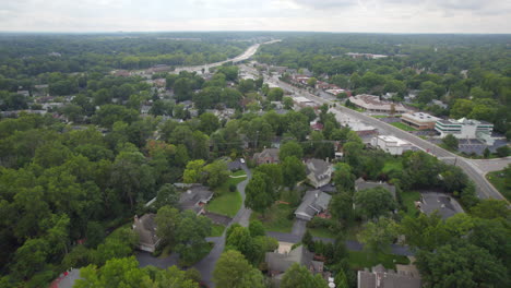 Aerial-over-suburban-neighborhood-towards-highway-in-the-midwest-on-a-cloudy-day