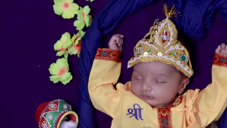 newborn-baby-boy-in-krishna-dressed-with-props-from-unique-perspective-in-different-expression