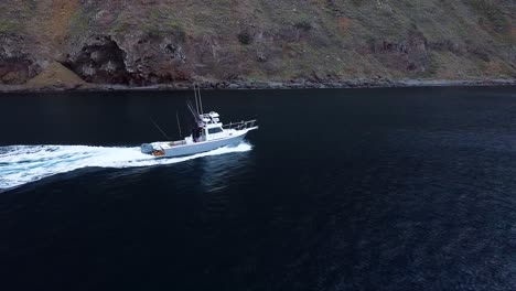 Parker-boat-driving-up-to-San-Clemente-island,-Aerial-view,-4k