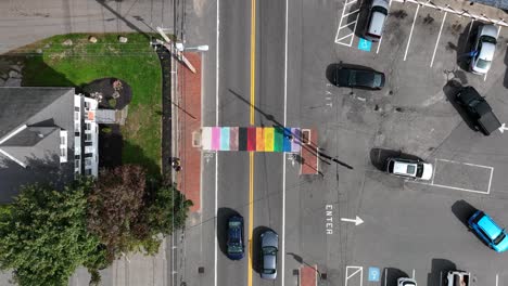 Top-down-aerial-of-LGBTQ-friendly-gay-queer-town-with-rainbow-pedestrian-crosswalk