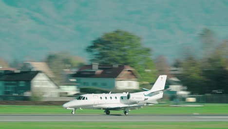 Private-Jet-taking-off-at-scenic-Austrian-airport-Salzburg-located-within-the-mountains