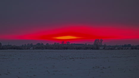 Leuchtend-Roter-Sonnenuntergang,-Während-Die-Sonne-Hinter-Dem-Horizont-Untergeht-Und-Einen-Leuchtend-Purpurroten-Himmel-Hinterlässt---Zeitraffer