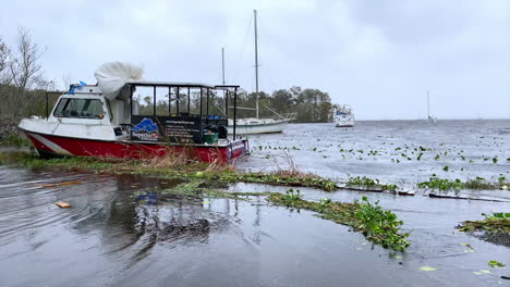 Scuba-boat-and-sailboats-in-flood-waters-after-hurricane-hits-Florida