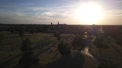 Ascending-aerial-shot-above-a-graveyard-during-sunset