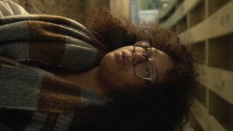 Vertical-video-portrait-black-woman-with-curly-hair-and-glasses