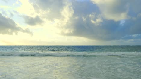 low-waves-of-a-calm-ocean-strand-on-a-lonely-deserted-sandy-beach
