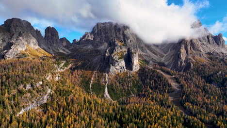 Clouds-climbing-South-Tyrol-Tre-Cime-woodland-mountain-range-rising-up-rugged-peaks-time-lapse