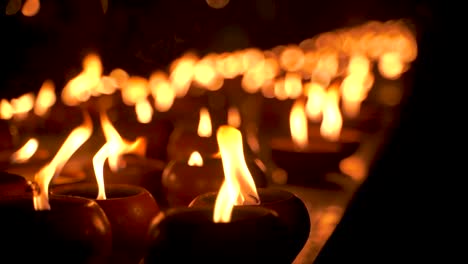 Mysterious-view-of-candles-at-night-burning-in-slow-motion,-close-up