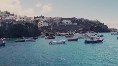 Boats-are-floating-near-the-coast-of-Madeira-island,-Portugal