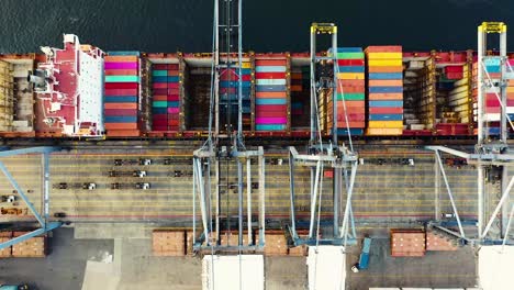 Aerial-view-of-ship-containers-at-a-business-sea-port,-logistics-transportation-concept