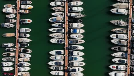 Top-down-aerial-view-taken-of-the-dock-of-Cala-d'Or-full-with-boats-on-Mallorca