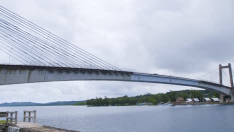 The-friendship-bridge-in-Palau-at-mid-day,-cloudy,-slow-motion