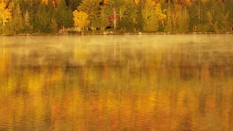 Spectacular-revealing-fog-over-Onawa-Lake-revealing-Borestone-Mountain-in-fall-colored-sunlight