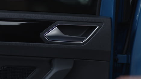 Close-up-pulling-the-door-handle-from-the-interior-of-a-car