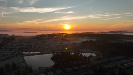 Wide-aerial-view-tilting-down-to-reveal-more-and-more-houses-under-the-Washington-sunrise