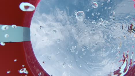 POV-emerging-from-water-through-a-red-lifebuoy