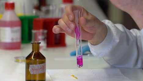 A-chemist-mixes-chemical-in-a-test-tube-at-the-lab