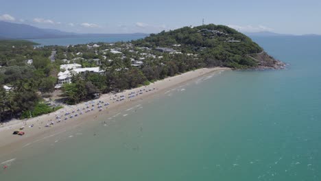 People-Enjoying-The-Calm-Water-In-Four-Mile-Beach,-Port-Douglas,-Queensland,-Australia---aerial-drone-shot