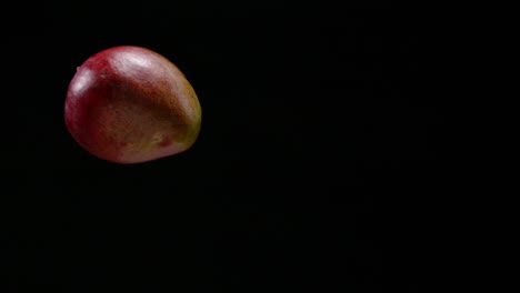 Frische-Mangofrüchte-Fallen-Mit-Schwarzem-Hintergrund,-Zeitlupe