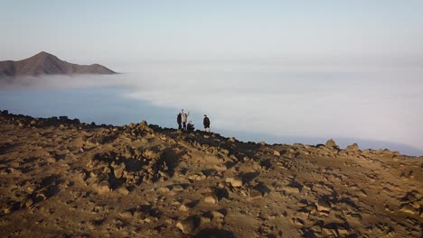 A-drone-shot-of-a-group-of-hikers-in-the-mountains-above-the-clouds-of-the-city-of-Lima-Peru