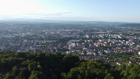 Banja-Luka-City-Aerial-Establishing,-Mountain-Foreground,-Dolly-In