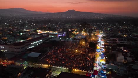 Aerial-view-around-the-illuminated-Mixquic-cementary,-during-day-of-the-dead,-sundown-in-Mexico-city