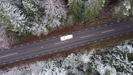 Round-shot-of-a-car-passing-by-on-a-road-in-winter