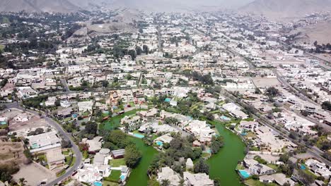 Drone-shot-of-of-lake-houses-in-the-suburbs-of-Lima-Peru