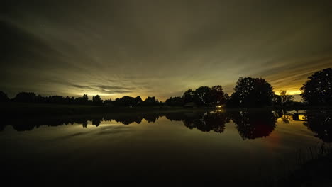 Dramatic-time-lapse-of-starry-milky-way-night-sky-changing-colors-and-reflection-on-water