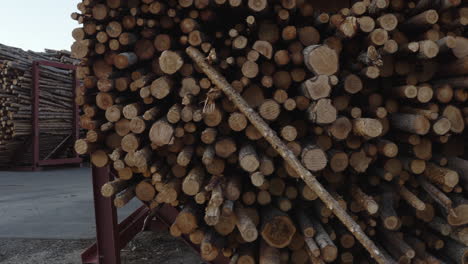 4k-Close-up-shot-of-piles-of-logs,-timber-and-wood-at-a-factory-in-Sweden