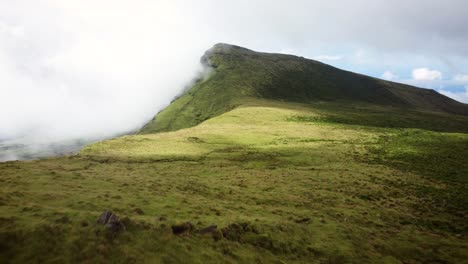 Azores,-Pico-island-highlands-with-ascending-transition-to-a-cloudy-epic-mountain