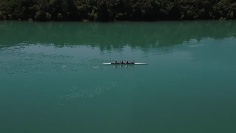 Aerial-view-of-team-crew-on-rowing-boat-over-a-beautiful-lake