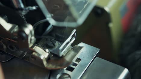 close-up-shot-of-industrial-sewing-machine-sewing-military-clothes