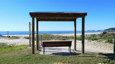 Wooden-Gazebo-And-Empty-Bench-On-The-Beach---Gold-Coast-Beach-And-Ocean---Queensland,-Australia-In-Summer