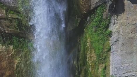 Aerial-Aescending-along-Majestic-Waterfall-and-Cliff-Wall,-Close-Up