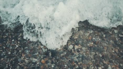 Close-up-shot-of-the-sea-wave-hitting-the-stony-beach