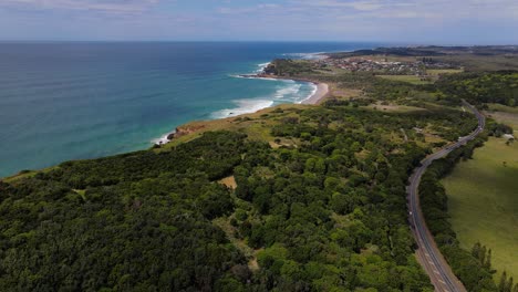 Road-to-Lennox-Head-Village-in-Australia-by-the-seaside-green-forest--aerial