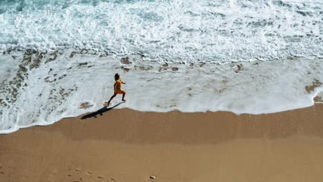 Aerial-shot-of-the-girl-on-the-beach