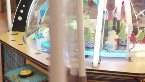 Arcade-game-machine-with-bonus-prize-tokens-spinning-in-a-commercial-mall