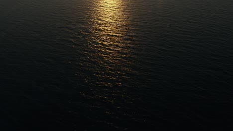 Aerial-shot-of-the-setting-sun-over-the-sea