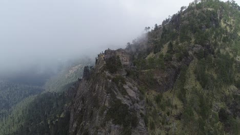 Aerial-pan-of-mountain-peak-in-Mexico-Michoacan-with-grey-rain-clouds